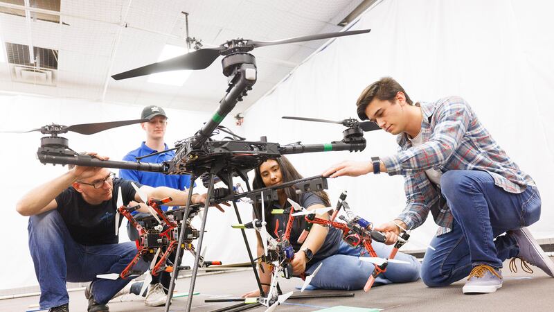 Huskers work on a drone swarm idea in a College of Engineering lab. The federal award will...