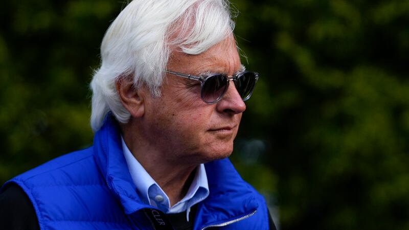 Bob Baffert, center, owner of Preakness Stakes entrant National Treasure, walks near the...