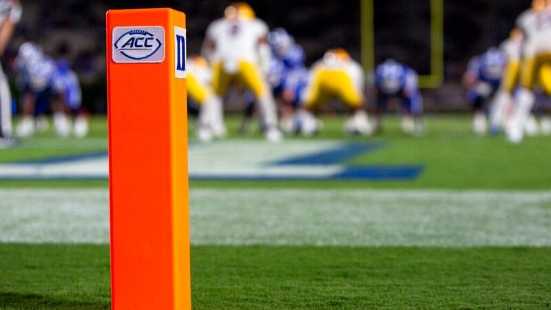 The ACC and Duke logos seen on a pylon at the back of and end zone during an NCAA college...