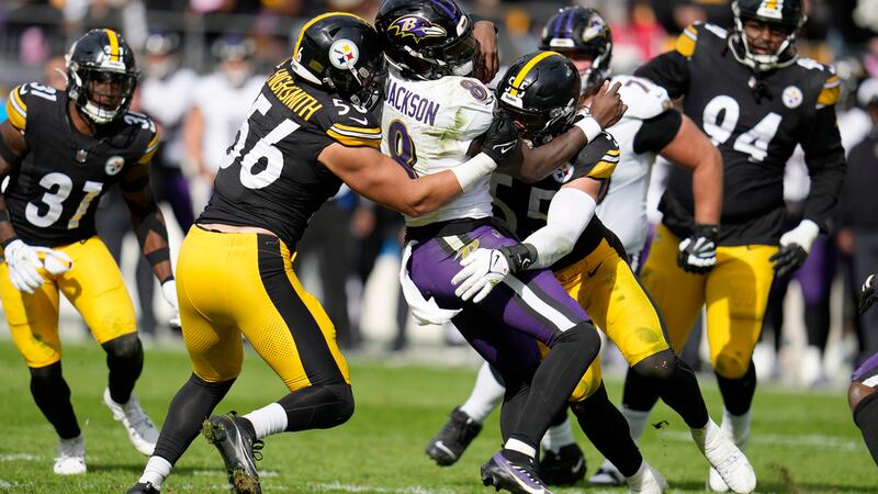 Pittsburgh Steelers linebacker Alex Highsmith (56) and linebacker Cole Holcomb (55) tackle...